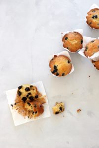 Birds Eye View of 5 blueberry muffins, with one muffin split open
